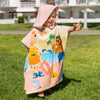 Barn i rosa Lollo och Bernie poncho